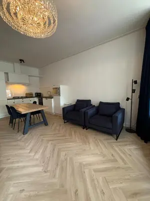 a living room with a couch and a table at The Blue House in Alkmaar