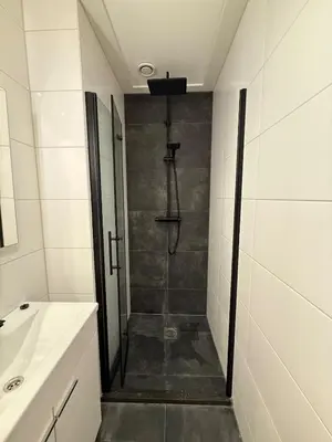 a bathroom with a shower and a sink at The Blue House in Alkmaar