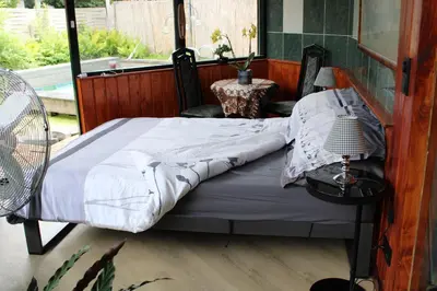 a bed in a room with a window at Temple of Hedon Wellness Spa and Sleep in Ankeveen