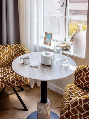 a table in a room with two chairs and a window at Suites aan de Gracht Utrecht in Utrecht