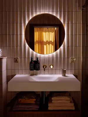 a bathroom with a white sink and a mirror at Suites aan de Gracht Utrecht in Utrecht