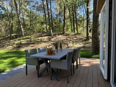 a table and chairs sitting on a porch at Samoza in Ons Belang