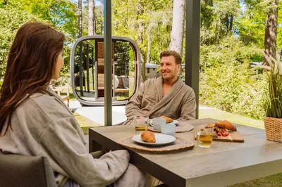 a man and woman sitting at a table eating food at Samoza in Ons Belang