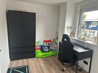 a room with a desk and a chair and a window at Paleisje aan zee in IJmuiden