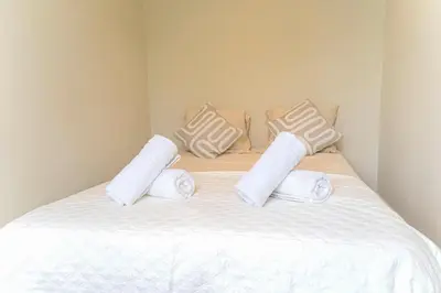 a bed with white towels and pillows on it at Charming Jordaan Apartment, Canal Views in Amsterdam