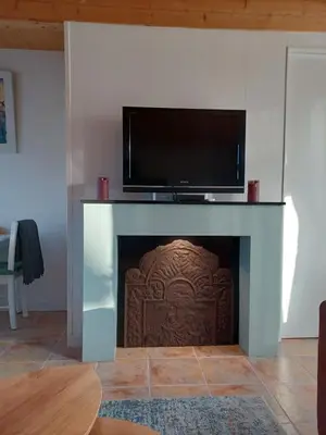 a fireplace with a flat screen tv on top of it at Guesthouse Het Woerdense Veerhuis in Woerden