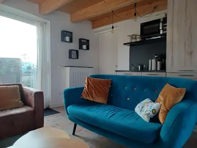 a blue couch in a living room with a table at Guesthouse Het Woerdense Veerhuis in Woerden