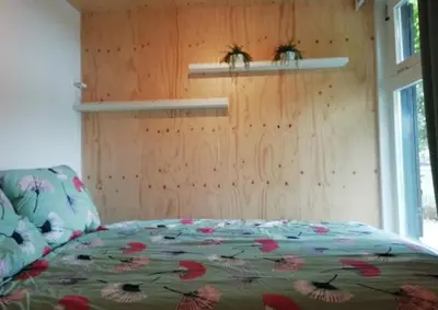 a bedroom with a bed with flowers on it at Guesthouse Het Woerdense Veerhuis in Woerden