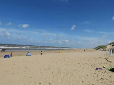 a group of people on a beach with tents at Holiday Home near Dutch Coast & Forest in Noordwijk