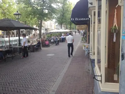 a group of people walking down a street at Holiday apartment in Alkmaar in Alkmaar