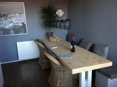 a dining room table with a bottle of wine on it at Holiday apartment in Alkmaar in Alkmaar