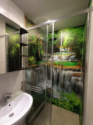 a bathroom with a shower with a waterfall mural on the wall at Stijlvolle Designstudio in Almere