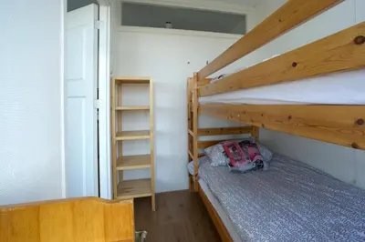 a bedroom with two bunk beds and a ladder at die Perle in Zandvoort