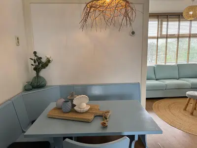 a living room with a table and a couch at die Perle in Zandvoort