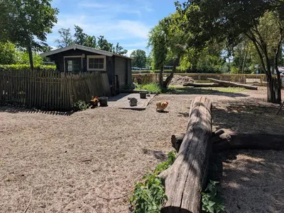 a wooden fence in a yard with a house at Holiday House 4 guests at Spaarnwoude in Velsen-Zuid