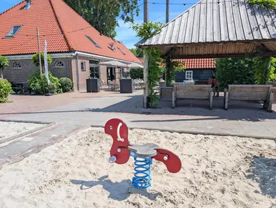 a skateboard in the sand in front of a building at Holiday House 4 guests at Spaarnwoude in Velsen-Zuid