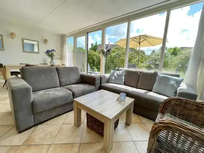 a living room with a couch and a table at Zon op de Wielen by Droomvilla in Sint Maarten