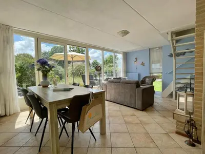 a living room with a table and chairs and a couch at Zon op de Wielen by Droomvilla in Sint Maarten