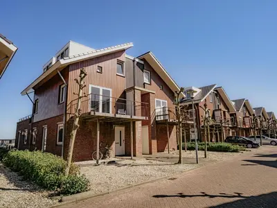 a row of houses on the side of a street at Nova Meer in Uitgeest