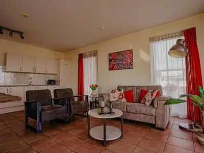 a living room with a couch and a table at Waterbase in Uitgeest