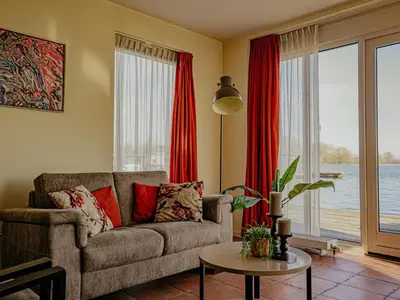 a living room with a couch and a table at Waterbase in Uitgeest