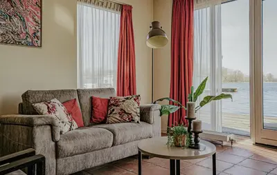 a living room with a couch and a table at Westergeest Beneden 2 Slaapk in Uitgeest