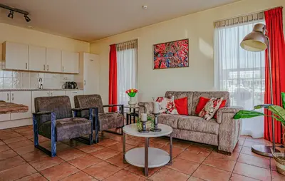 a living room with a couch and a table at Westergeest Beneden 2 Slaapk in Uitgeest