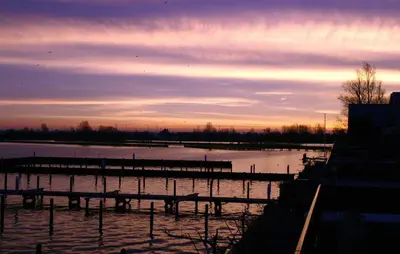 a view of a body of water at sunset at Westergeest Beneden 2 Slaapk in Uitgeest