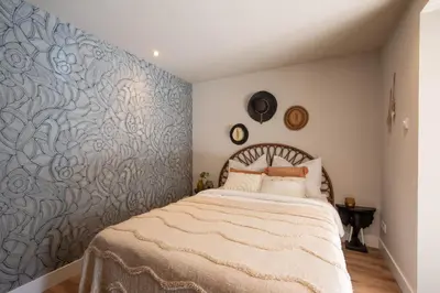 a bedroom with a bed with a blue wall at Beachbreak Boulevard in Katwijk aan Zee