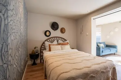 a bedroom with a large bed and a blue couch at Beachbreak Boulevard in Katwijk aan Zee