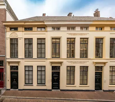 a large white building with black doors and windows at Zocher6 a monumental town house in the city center in Utrecht