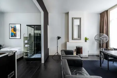 a living room with a couch and a table at Zocher6 a monumental town house in the city center in Utrecht
