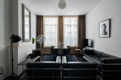 a living room with a couch and a table at Zocher6 a monumental town house in the city center in Utrecht