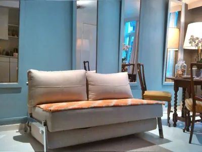 a couch in a room with blue walls and a table at Miss Jordaan for Quiet Travellers in Amsterdam