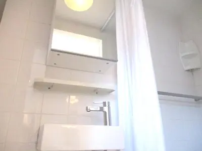 a bathroom with a sink and a mirror and a window at Miss Jordaan for Quiet Travellers in Amsterdam