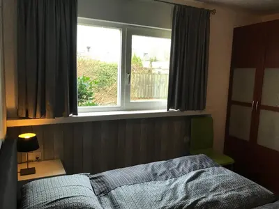 a bedroom with a bed and a window at Fewo Klimduin Castricum in Castricum