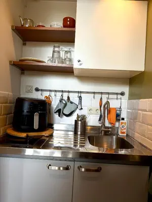 a kitchen with a sink and a microwave at Cosy Studio, with outdoor swimming in Amsterdam