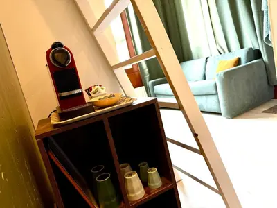 a room with a ladder and a table with a mirror at Cosy Studio, with outdoor swimming in Amsterdam