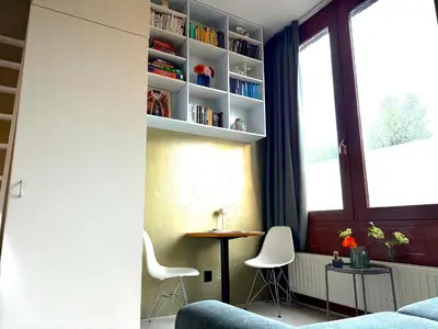 a room with a table and chairs and a window at Cosy Studio, with outdoor swimming in Amsterdam