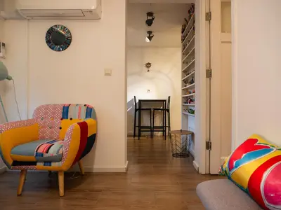a living room with a chair and a table at Garden Apartment, Amsterdam in Amsterdam