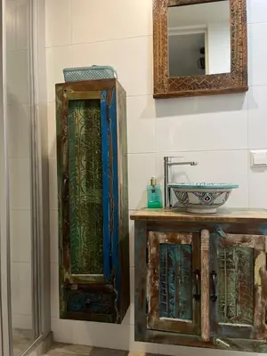 a bathroom with a glass cabinet and a sink at Garden Apartment, Amsterdam in Amsterdam