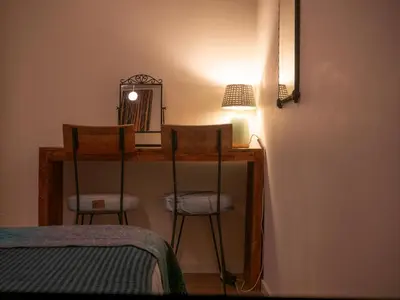 a room with two chairs and a table with a mirror at Garden Apartment, Amsterdam in Amsterdam