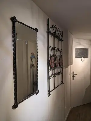 a mirror on a wall next to a door at Garden Apartment, Amsterdam in Amsterdam