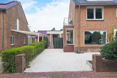 a brick house with a driveway between two buildings at Nofa 7 - Zandvoort in Zandvoort