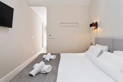 a bedroom with two beds with towels on the floor at Nofa 7 - Zandvoort in Zandvoort