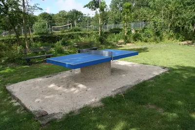 a blue bench in a field with a park at Rekerlanden 270 in Warmenhuizen