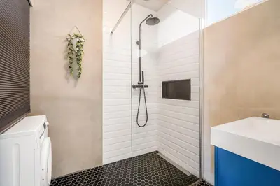 a bathroom with a shower and a sink at Light and quiet haven next to park in Amsterdam