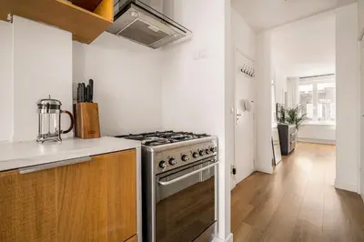 a kitchen with a stove and a counter top at Light and quiet haven next to park in Amsterdam