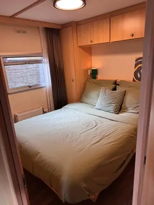 a bedroom with a large bed in a room at Vlinderzicht in Koedijk