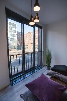 a bedroom with a balcony with a view of a city at Apartment 4G in Amersfoort